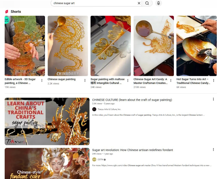 YouTube搜索chinese sugar art的结果页，多条糖画视频，3D立体糖画19万播放，中国日报的糖画视频2.2万播放，麦芽糖糖画非遗24万播放，糖画大师制作过程21万播放