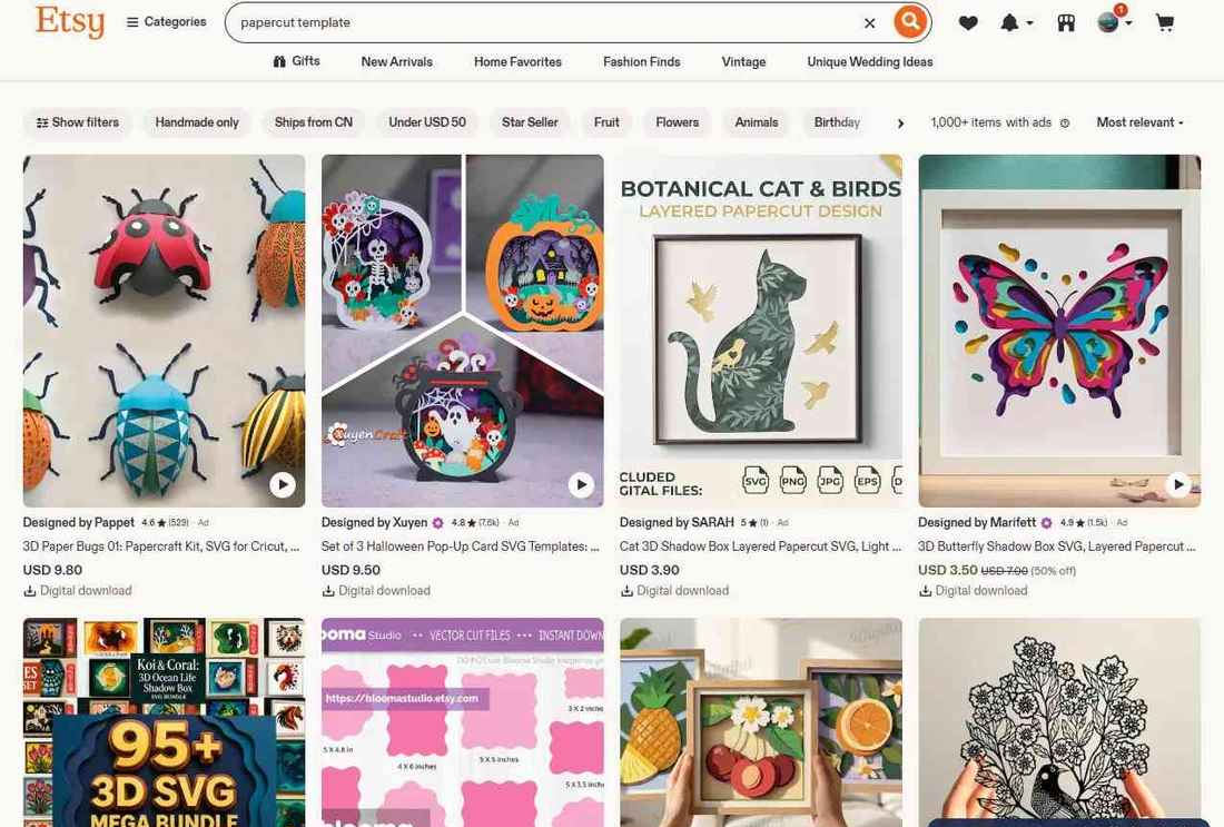Etsy搜索papercut template的结果页,1000多件商品,包括9.80美元的3D纸昆虫套件、3.90美元的猫咪立体阴影盒、3.50美元的3D蝴蝶阴影盒